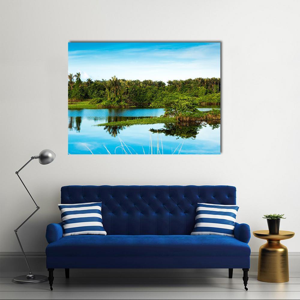 Amazon Wetland Reflection Canvas Wall Art in green and blue, single panel hung on a wall