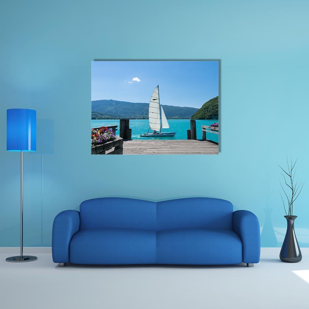 White Sailboat on Turquoise Lake Canvas Wall Art in white, green and blue, single panel hung on a wall