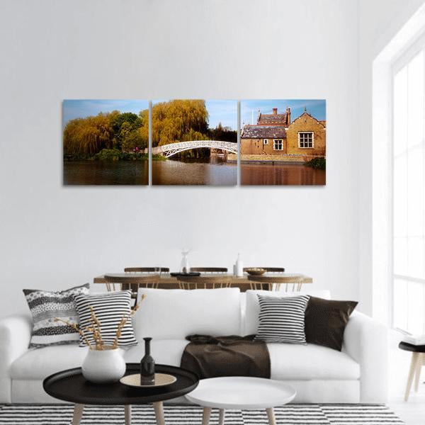 Mathematical Bridge Over River Cam Panoramic Canvas Wall Art in brown, green and blue, hung on a wall