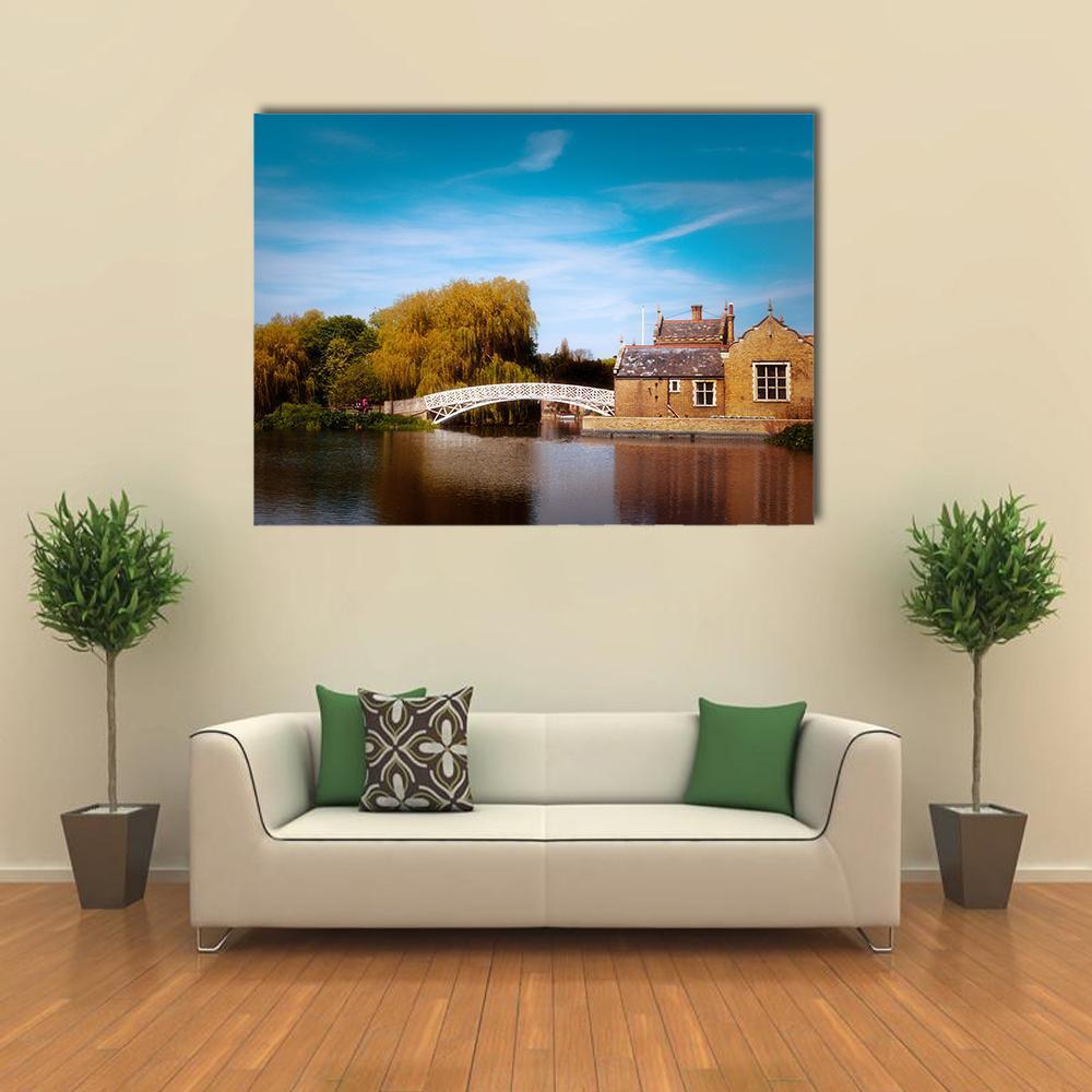 White Chinese Bridge Over River Canvas Wall Art in brown, green and blue, single panel hung on a wall