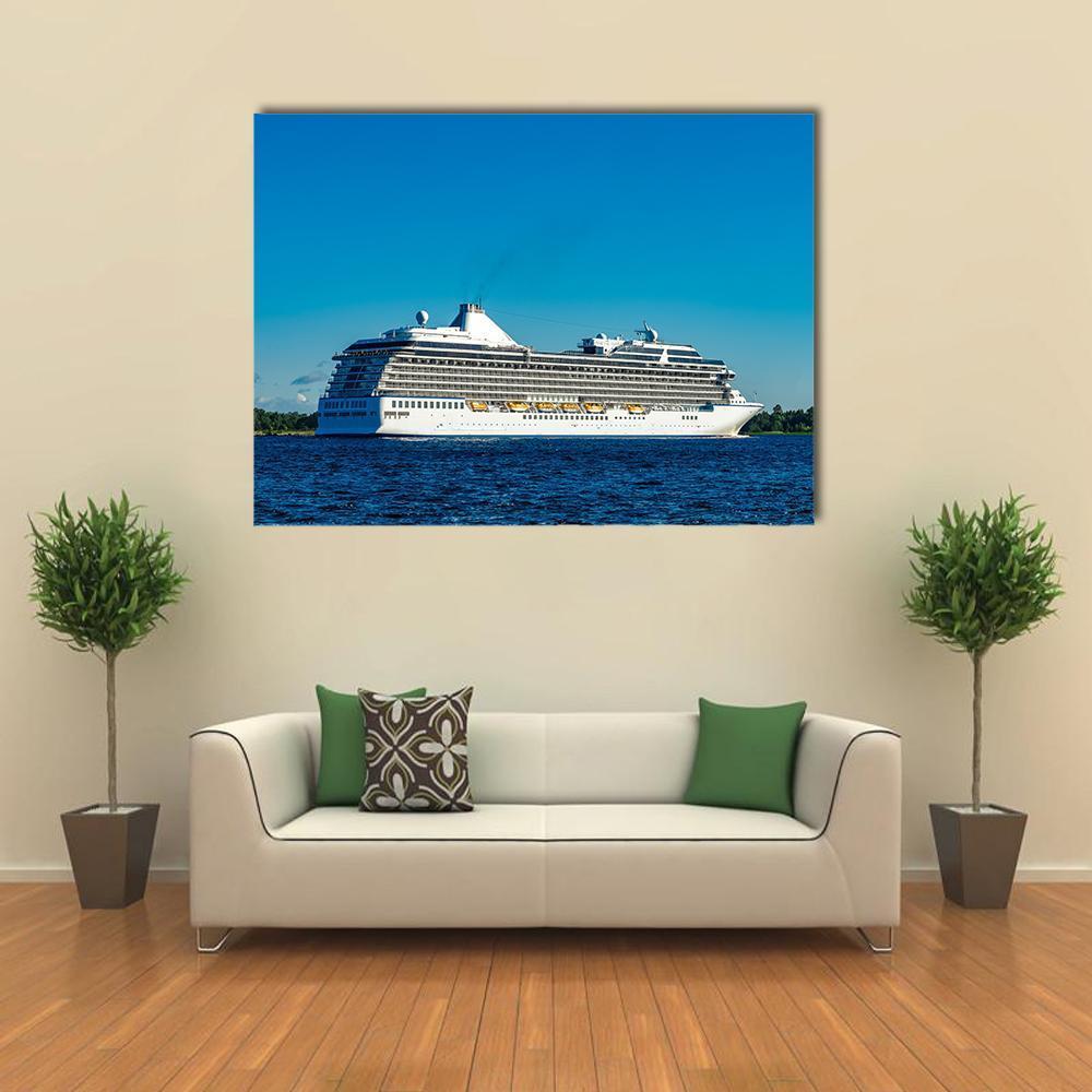 White Cruise Ship at Sea Canvas Wall Art in white and blue, single panel hung on a wall