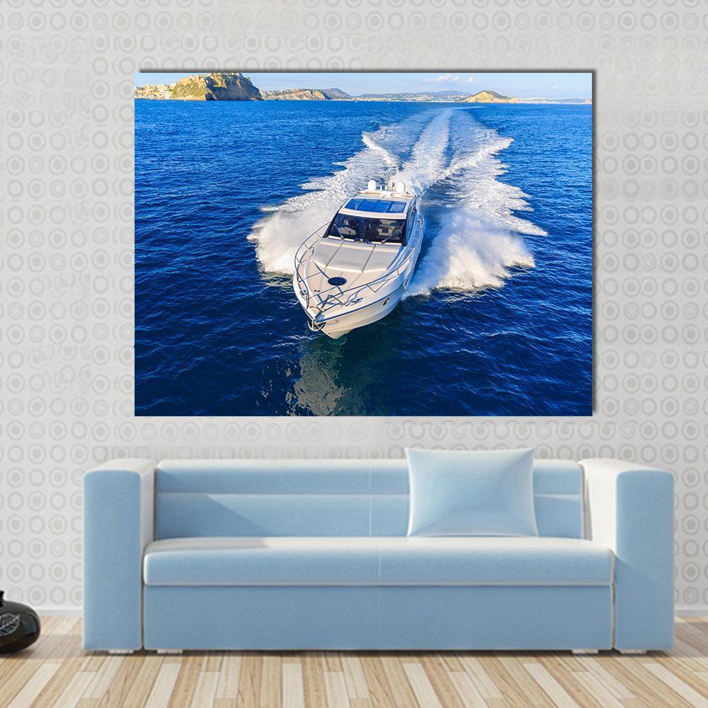 White Yacht in Ocean Canvas Wall Art in white and blue, single panel hung on a wall