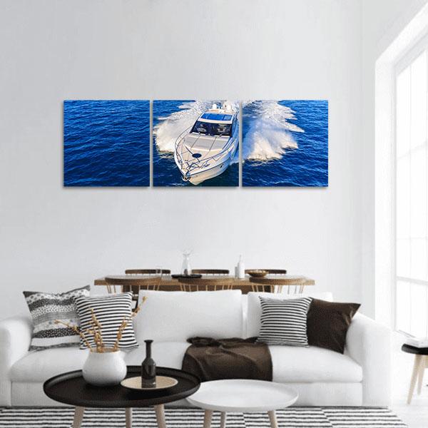 White Motorboat on Deep Blue Ocean Panoramic Canvas Wall Art in white and blue, single panel hung on a wall