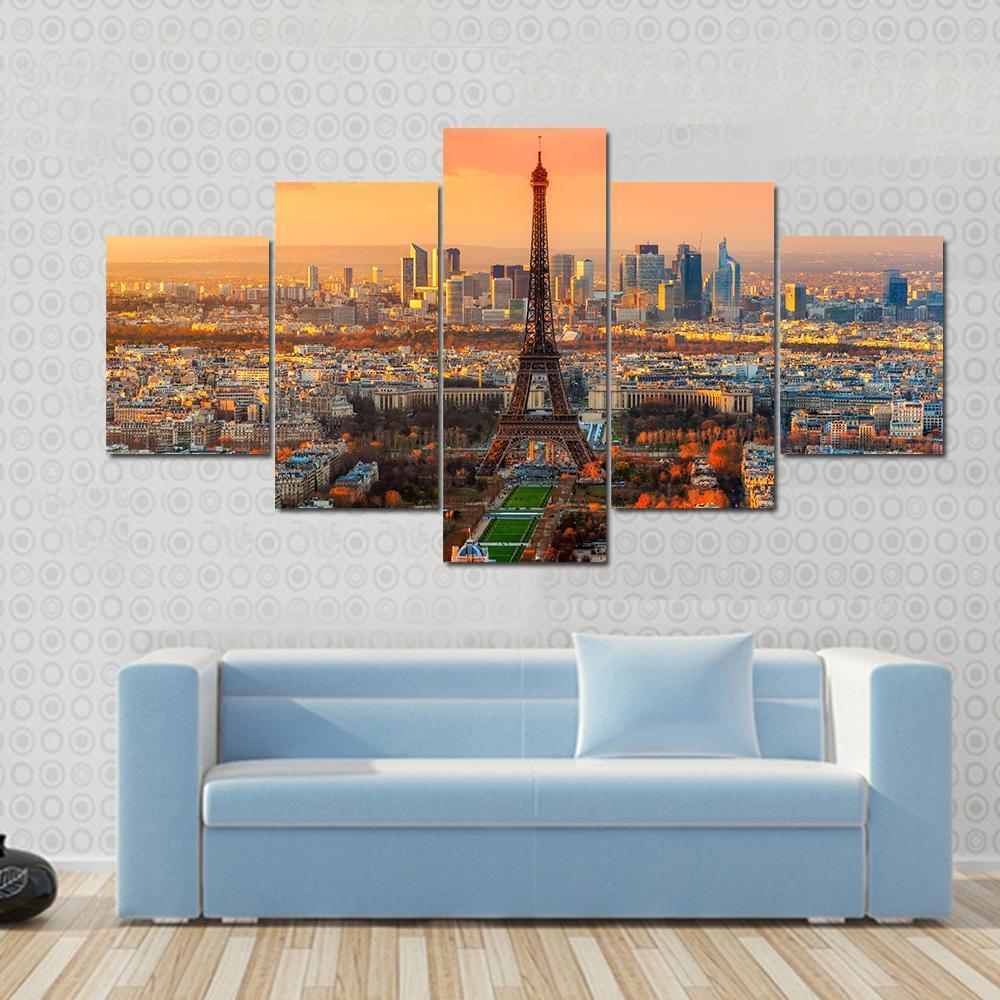 Paris Twilight View Canvas Wall Art in orange, yellow and blue, 5 panel Star layout hung on a wall