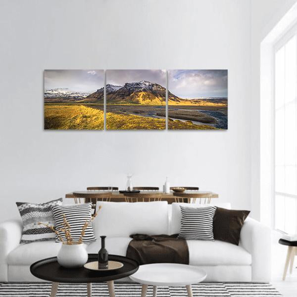 Iceland Snow-capped Valley Landscape Panoramic Canvas Wall Art in gray, yellow and blue, hung on a wall
