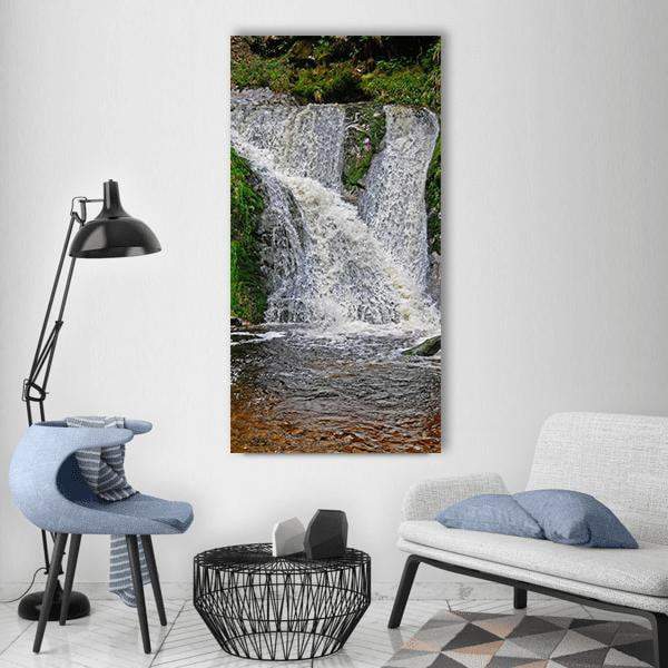 Wild Forest Waterfall with Mossy Rocks Vertical Canvas Wall Art in white, gray and green, single vertical panel hung on a wall