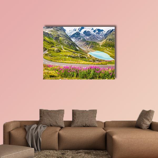 Winding Mountain Road with Alpine Lake Canvas Wall Art in gray, green and blue, single panel hung on a wall