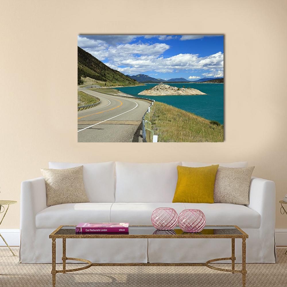 Winding Road and Turquoise Lake Canvas Wall Art in gray, green and blue, single panel hung on a wall