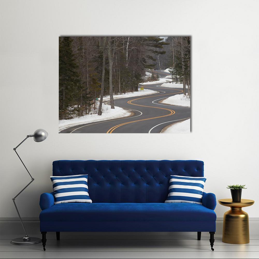 Winding Road in Winter Canvas Wall Art in black, white and gray, single panel hung on a wall