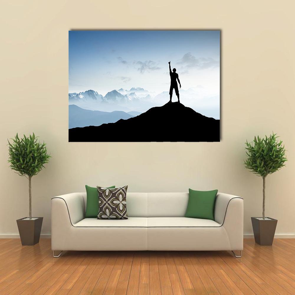 Victorious Silhouette on Mountain Peak Canvas Wall Art in black, white and blue, single panel hung on a wall