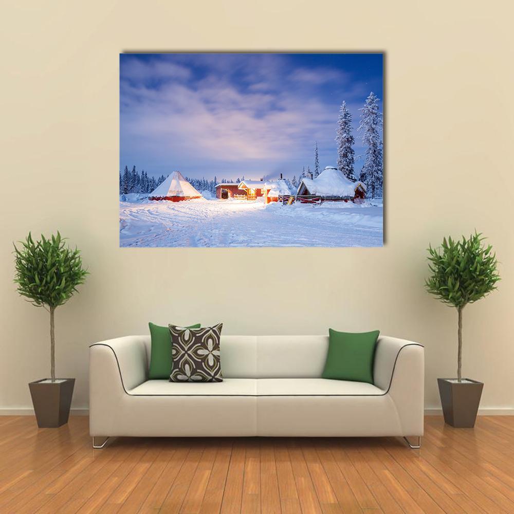 Winter Landscape with Cabin at Night Canvas Wall Art in white and blue, single panel hung on a wall
