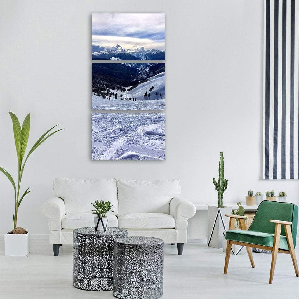 Ski Tracks in Mountain Valley Vertical Canvas Wall Art in white, gray and blue, single vertical panel hung on a wall