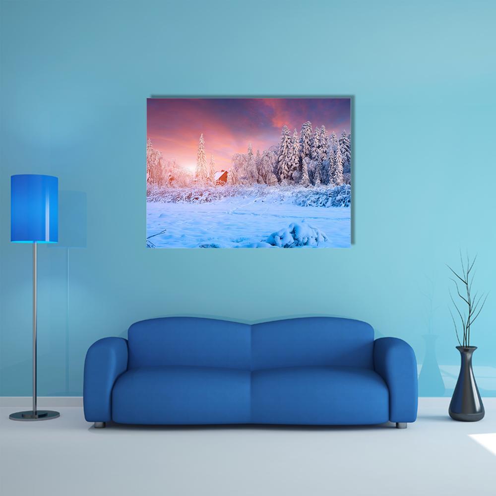 Snow-covered Field with Red Cabin at Sunset Canvas Wall Art in white, orange and blue, single panel hung on a wall