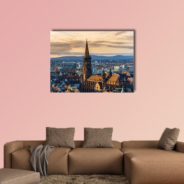 Winter Sunset Over Cathedral Spire Canvas Wall Art in brown, orange and blue, single panel hung on a wall