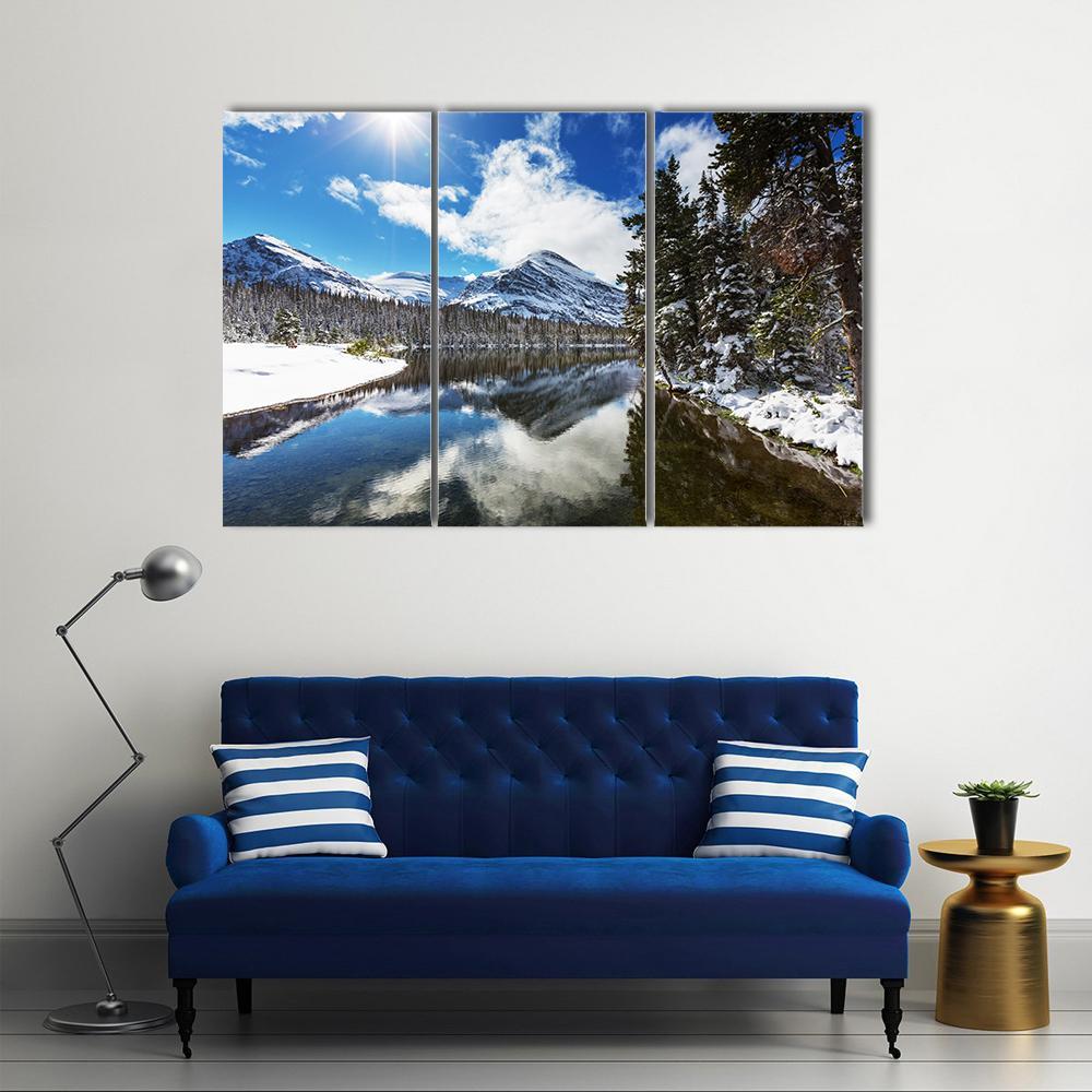 Winter View of Glacier National Park Canvas Wall Art in white and blue, 3 panel horizontal set hung on a wall