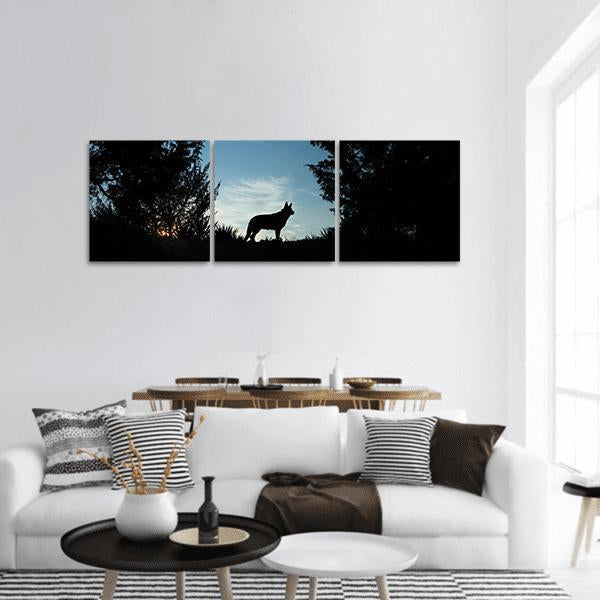 Wolf Dog at Dusk Panoramic Canvas Wall Art in black, white and blue, hung on a wall