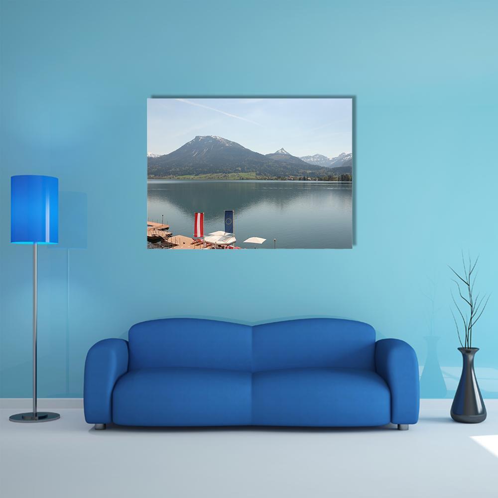 Wolfgangsee Lake with Dock and Snow-capped Mountains Canvas Wall Art in white, gray and blue, single panel hung on a wall