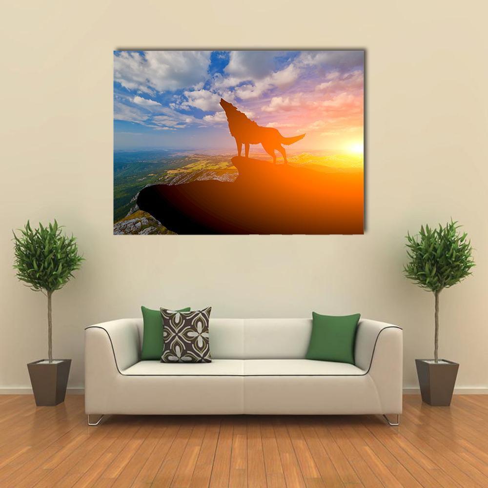 Howling Wolf on Mountain Top Canvas Wall Art in orange, yellow and blue, single panel hung on a wall