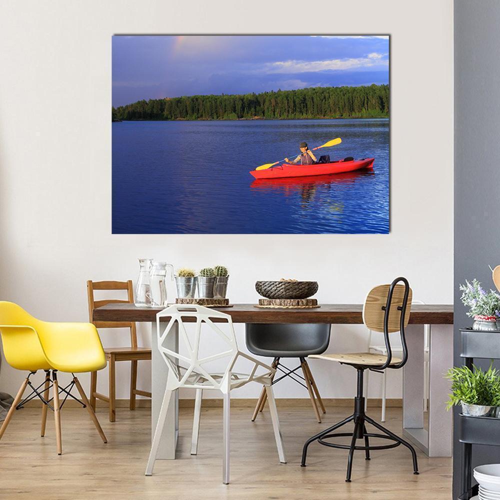 Red Kayak on Calm Blue Lake Canvas Wall Art in red, green and blue, single panel hung on a wall