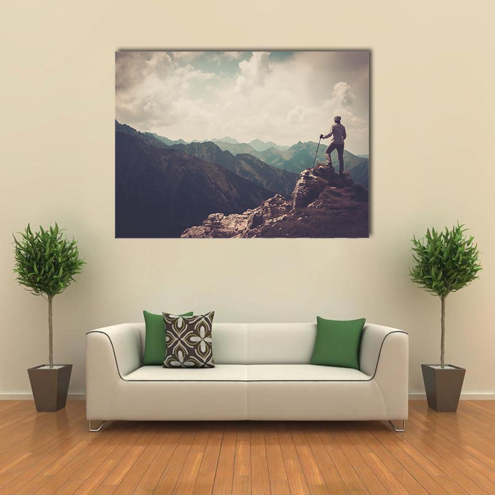 Woman Hiker on Mountain Summit Canvas Wall Art in gray, beige and blue, single panel hung on a wall