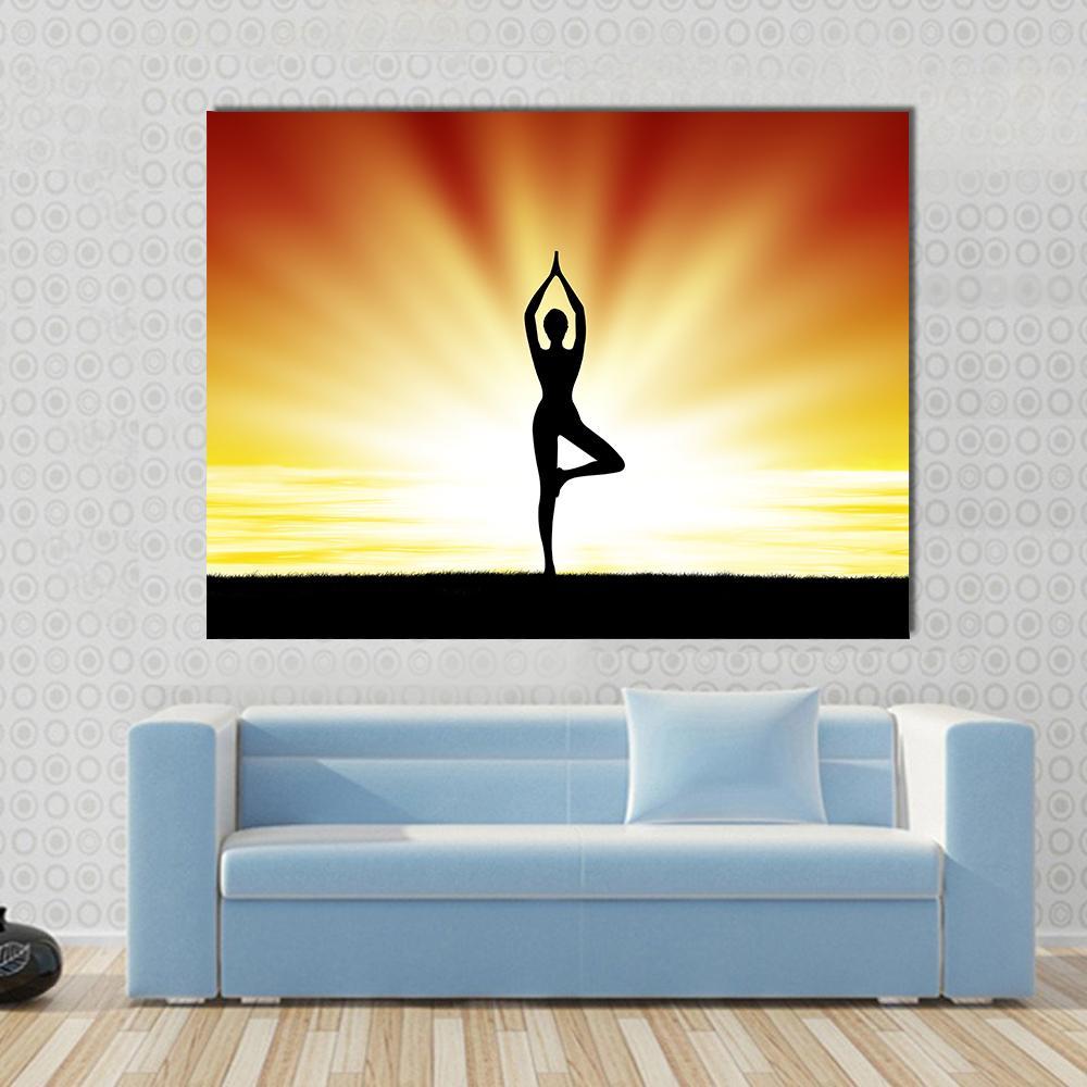 Woman Practicing Yoga at Sunset Canvas Wall Art in black, orange and yellow, single panel hung on a wall