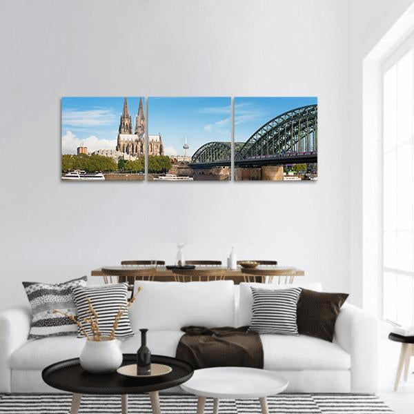 Cologne Cathedral and Hohenzollern Bridge Panoramic Canvas Wall Art in gray, green and blue, hung on a wall