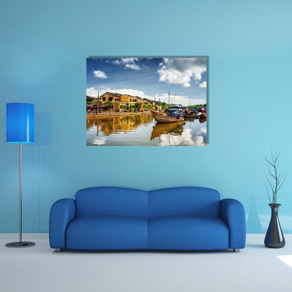 Wooden Boats on Thu Bon River Canvas Wall Art in brown, yellow and blue, single panel hung on a wall