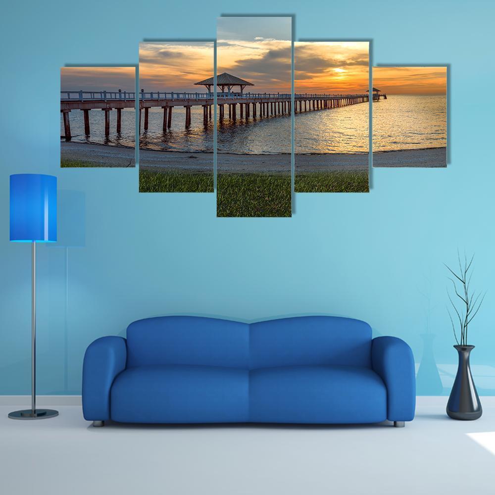 Wooden Pier with Gazebo at Sunset Canvas Wall Art in orange, yellow and blue, 5 panel Star layout hung on a wall