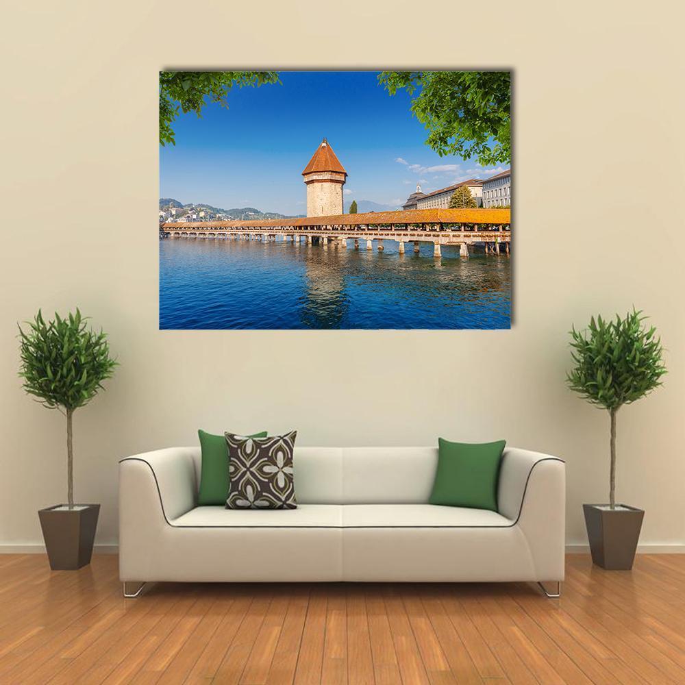 Wooden Chapel Bridge in Luzern Canvas Wall Art in brown, green and blue, single panel hung on a wall