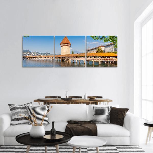 Chapel Bridge and Water Tower, Lucerne Panoramic Canvas Wall Art in brown, orange and blue, hung on a wall