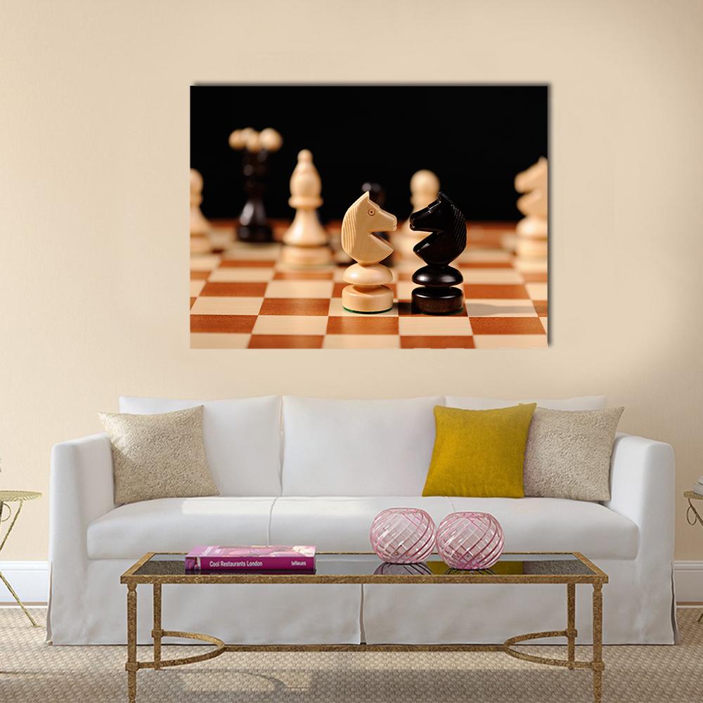 Facing Knights on Wooden Chessboard Canvas Wall Art in black, beige and brown, single panel hung on a wall