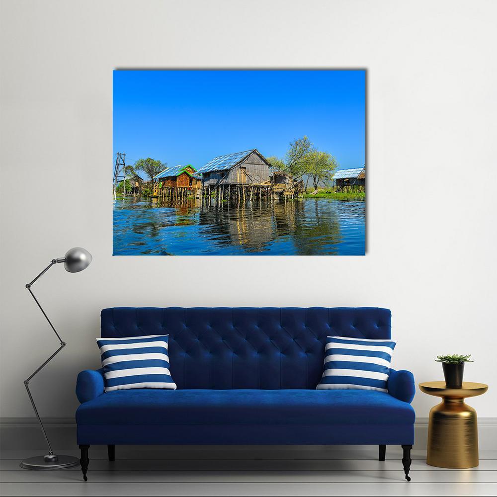 Wooden Houses in Floating Village Canvas Wall Art in brown and blue, single panel hung on a wall