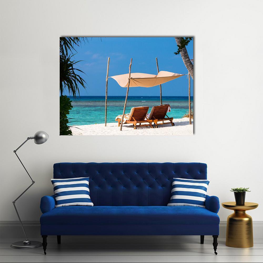 Two Lounge Chairs on Tropical Beach Canvas Wall Art in white, beige and blue, single panel hung on a wall