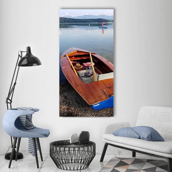 Wooden Rowboat on Calm Lake Vertical Canvas Wall Art in brown and blue, single vertical panel hung on a wall