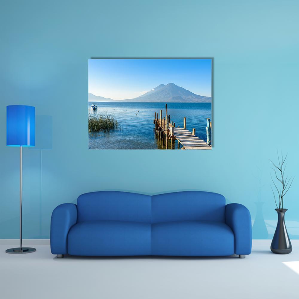 Wooden Pier by Mountain Lake Canvas Wall Art in brown and blue, single panel hung on a wall