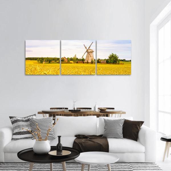 Wooden Windmill in Belarus Wheat Field Panoramic Canvas Wall Art in white, yellow and blue, hung on a wall