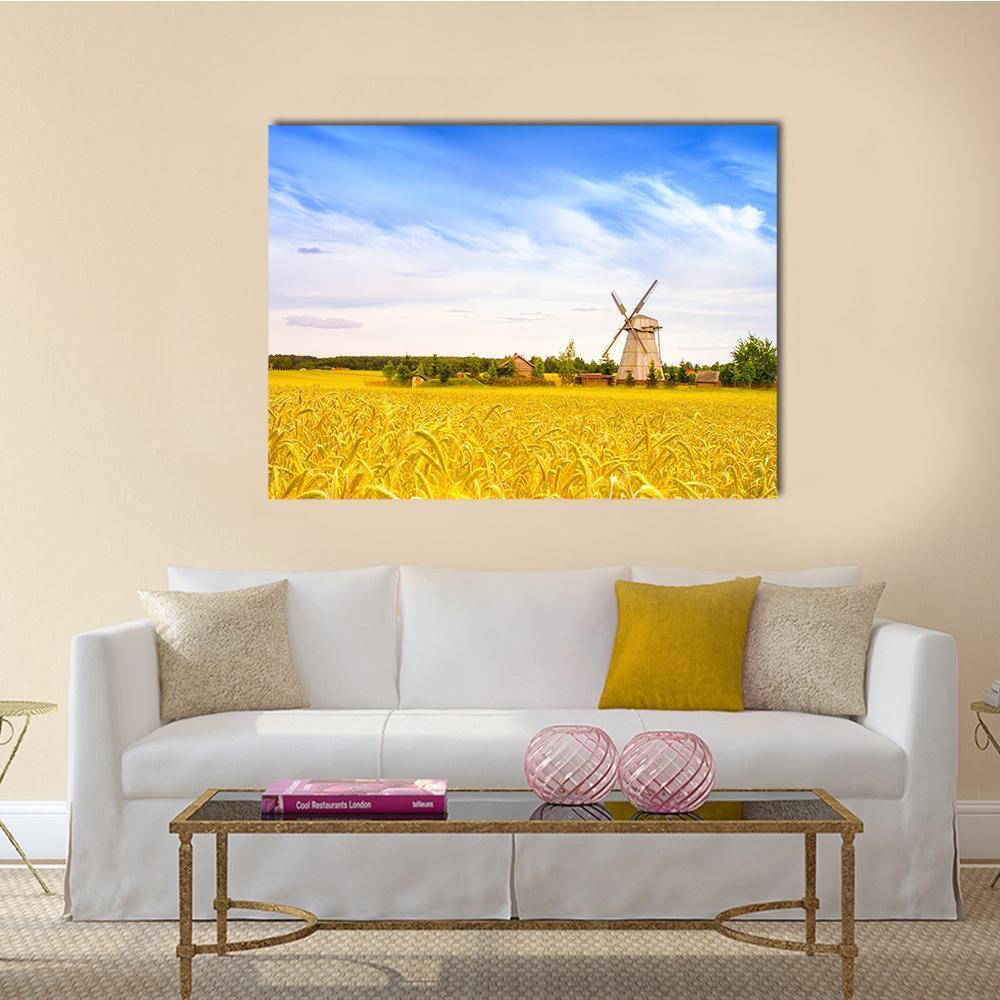 Wooden Windmill in Wheat Field Canvas Wall Art in gold, yellow and blue, single panel hung on a wall