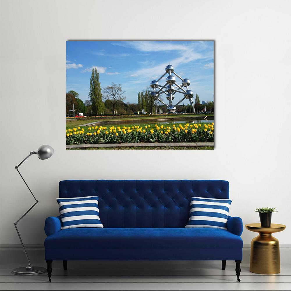 Atomium and Tulips in Brussels Canvas Wall Art in yellow, green and blue, single panel hung on a wall