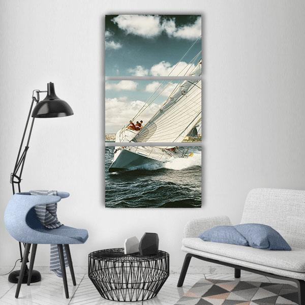 Sailboat Illustration with Crew and Taut Sails Vertical Canvas Wall Art in white, beige and blue, hung on a wall