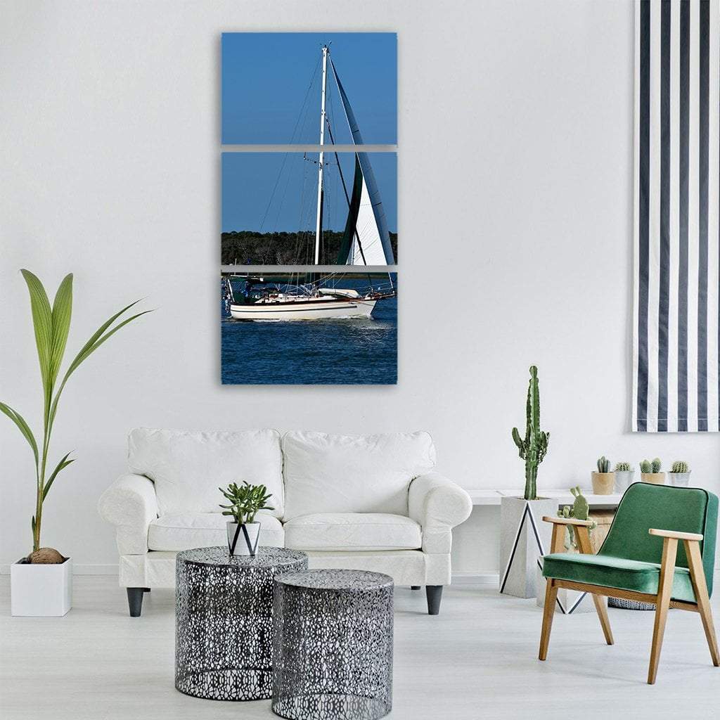 Single-masted Sailboat with Green Sail Vertical Canvas Wall Art in white, green and blue, single vertical panel hung on a wall