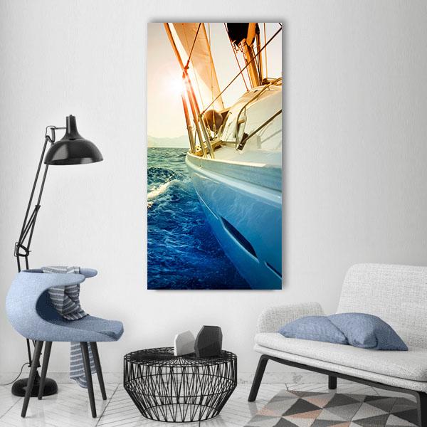 Yacht Sailing at Sunset Vertical Canvas Wall Art in orange, yellow and blue, hung on a wall