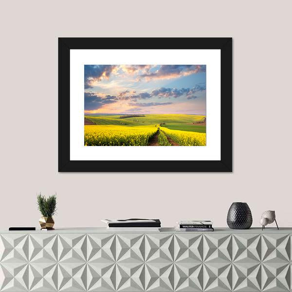 Field of Yellow Flowers with Winding Path Canvas Wall Art in yellow, green and blue, single panel hung on a wall