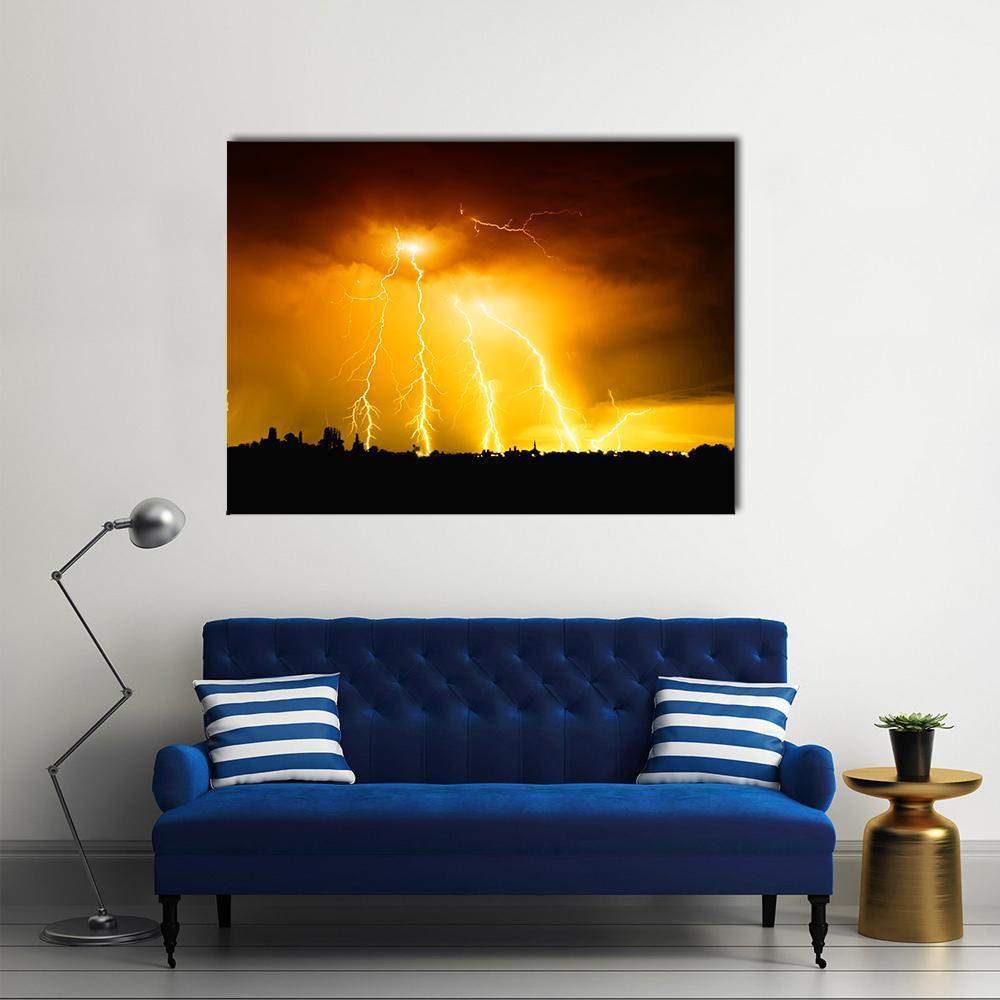 Yellow Lightning Over City Skyline Canvas Wall Art in black, orange and yellow, single panel hung on a wall