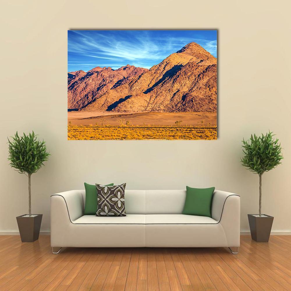 Yellow Mountains of Namib Desert Canvas Wall Art in brown, yellow and blue, single panel hung on a wall