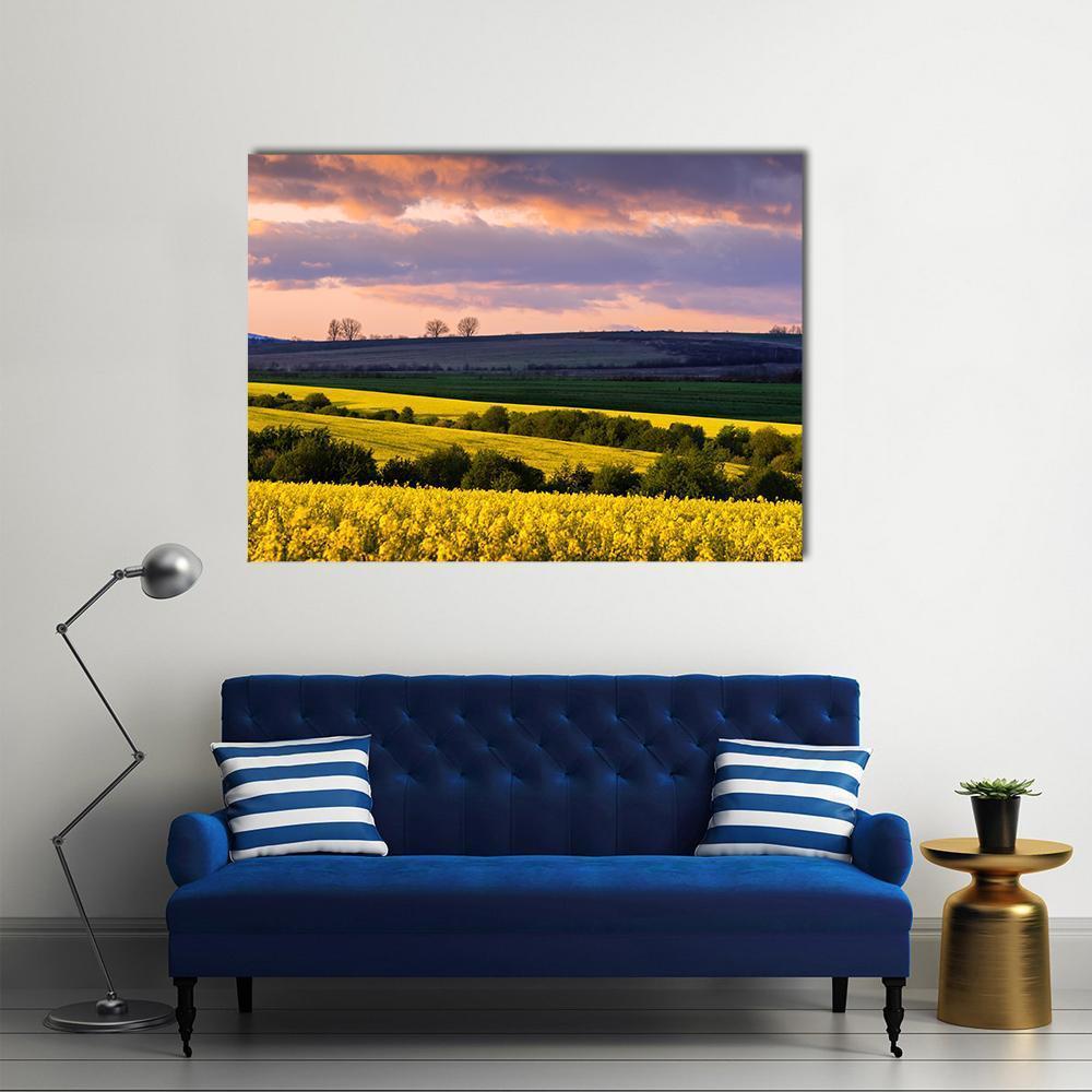 Yellow Rape Fields Under Blue Sky Canvas Wall Art in yellow, blue and purple, single panel hung on a wall