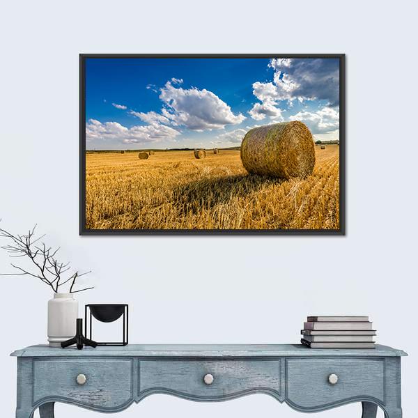 Yellow Hay Bale in a Summer Field Canvas Wall Art in gold, yellow and blue, framed canvas, product view on a white background