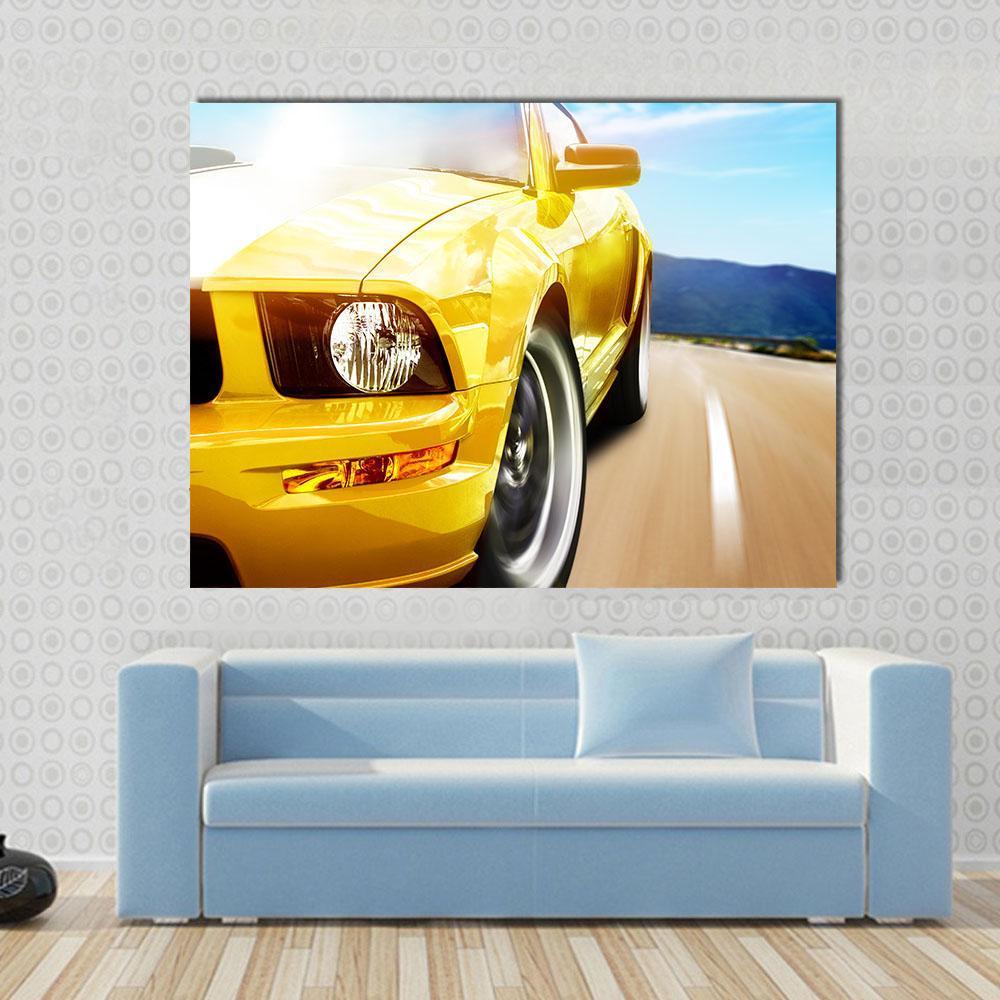 Yellow Sport Car on a Narrow Road Canvas Wall Art in brown, yellow and blue, single panel hung on a wall