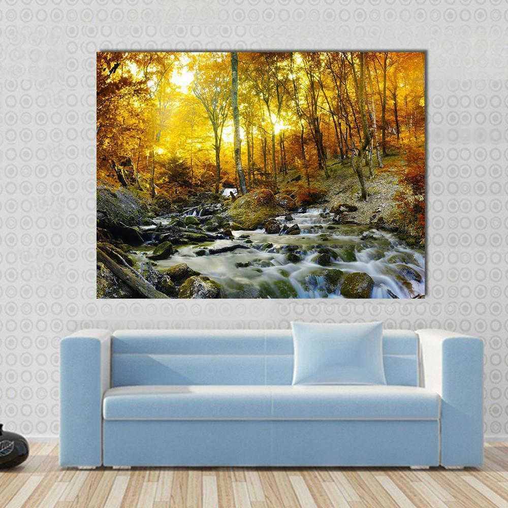 Golden Forest Stream with Mossy Rocks Canvas Wall Art in gold, yellow and green, single panel hung on a wall