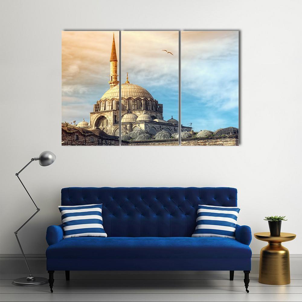 Yeni Cami Mosque at Sunset, Istanbul Canvas Wall Art in beige, orange and blue, 3 panel horizontal set hung on a wall