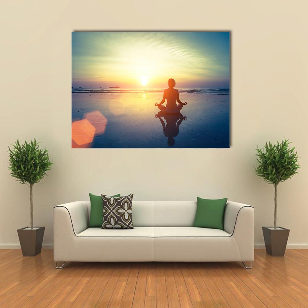 Yoga Woman at Sunset Canvas Wall Art in orange, yellow and blue, single panel hung on a wall
